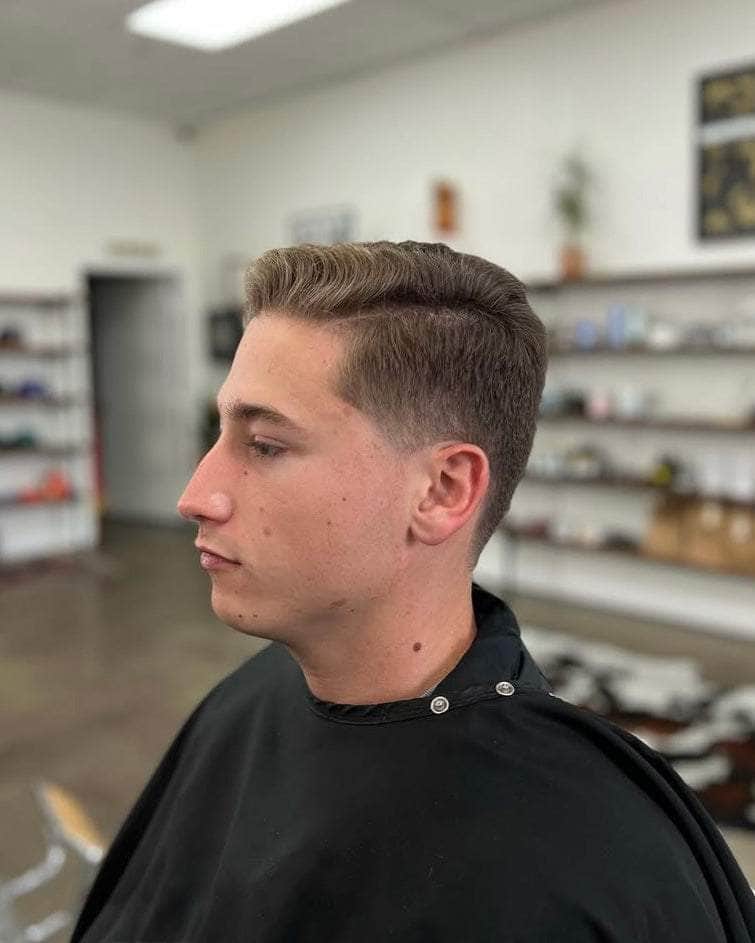 Wolf’s Head Clay Pomade used on classic side part haircut at Wolf’s Head Barbershop in Santa Barbara – strong hold with matte no shine finish