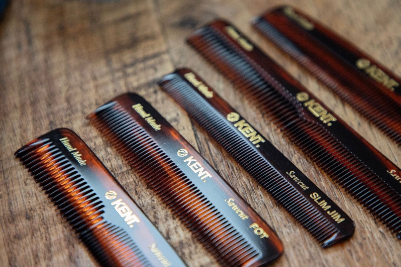Set of Kent combs on wooden surface – handmade grooming tools for barbershop-quality styling and daily use. Available at Wolf's Head