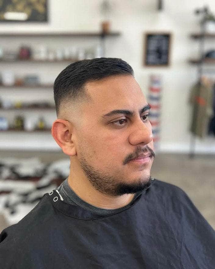 Wolf’s Head Water Soluble Pomade used on clean haircut at Wolf's Head Barbershop in Santa Barbara – strong hold, shine finish water based hair product made in California