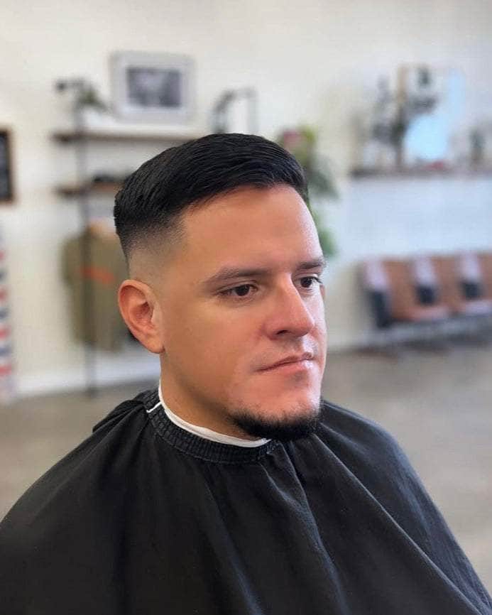 Wolf’s Head Styling Gel Pomade used on side combed haircut at Wolf’s Head Barbershop in Santa Barbara – strong hold high shine water based hair product made in California