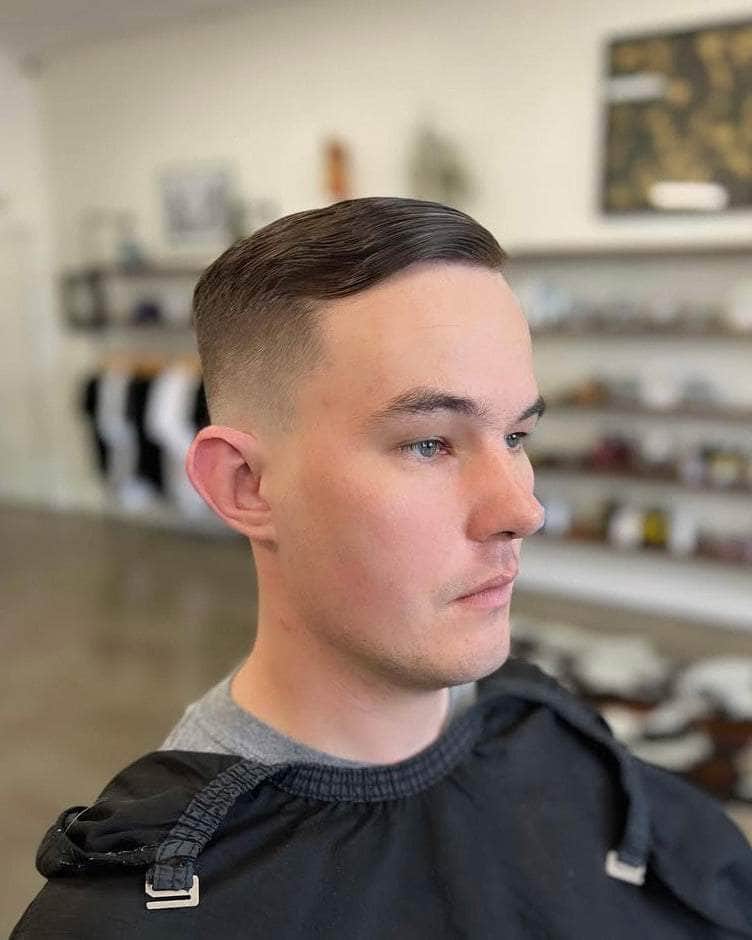 Wolf’s Head Styling Gel Pomade used on comb over hairstyle at Wolf’s Head Barbershop in Santa Barbara – strong hold high shine water based hair product made in California