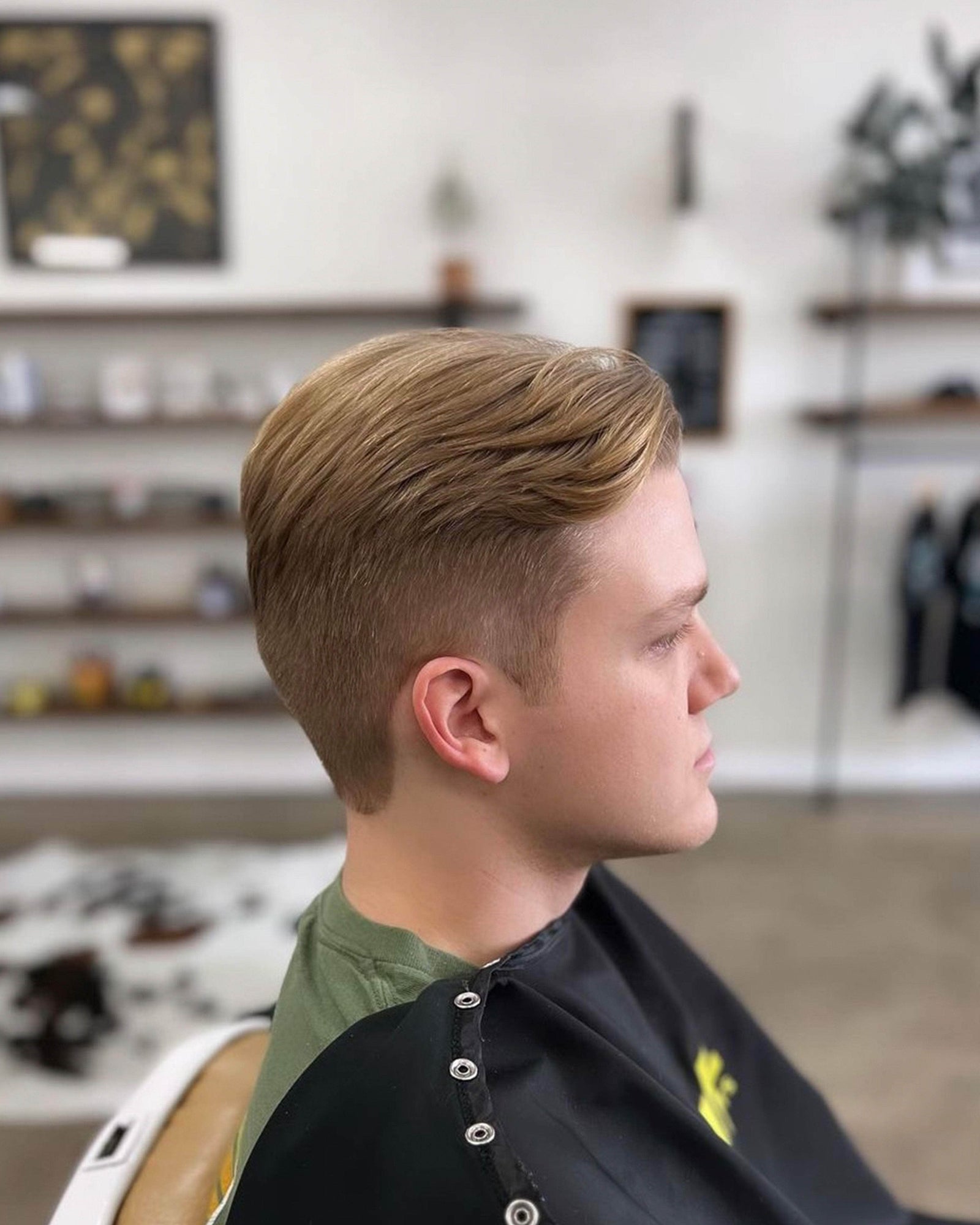 Wolf’s Head Clay Pomade used on mid length hairstyle at Wolf's Head Barbershop in Santa Barbara – Strong Hold, Matte Finish Grooming Product. Made in California
