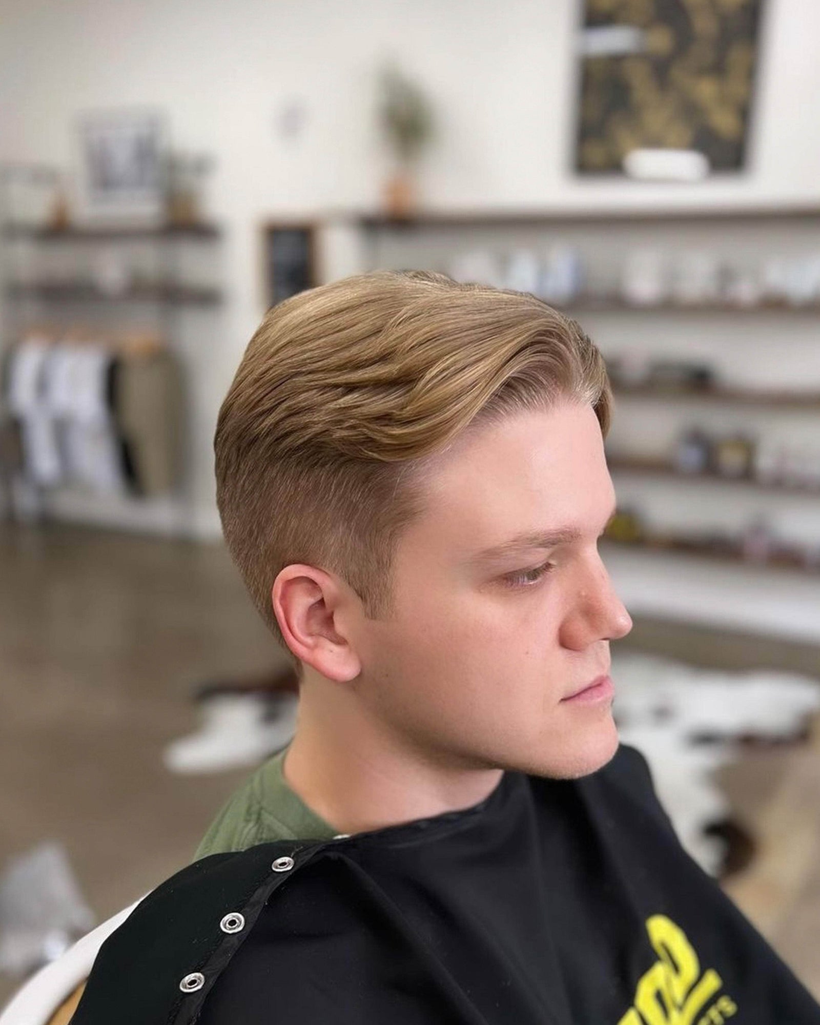 Wolf’s Head Clay Pomade in use  on mid length hairstyle at Wolf's Head Barbershop in Santa Barbara – Strong Hold, Matte Finish Hair Product. Made in California