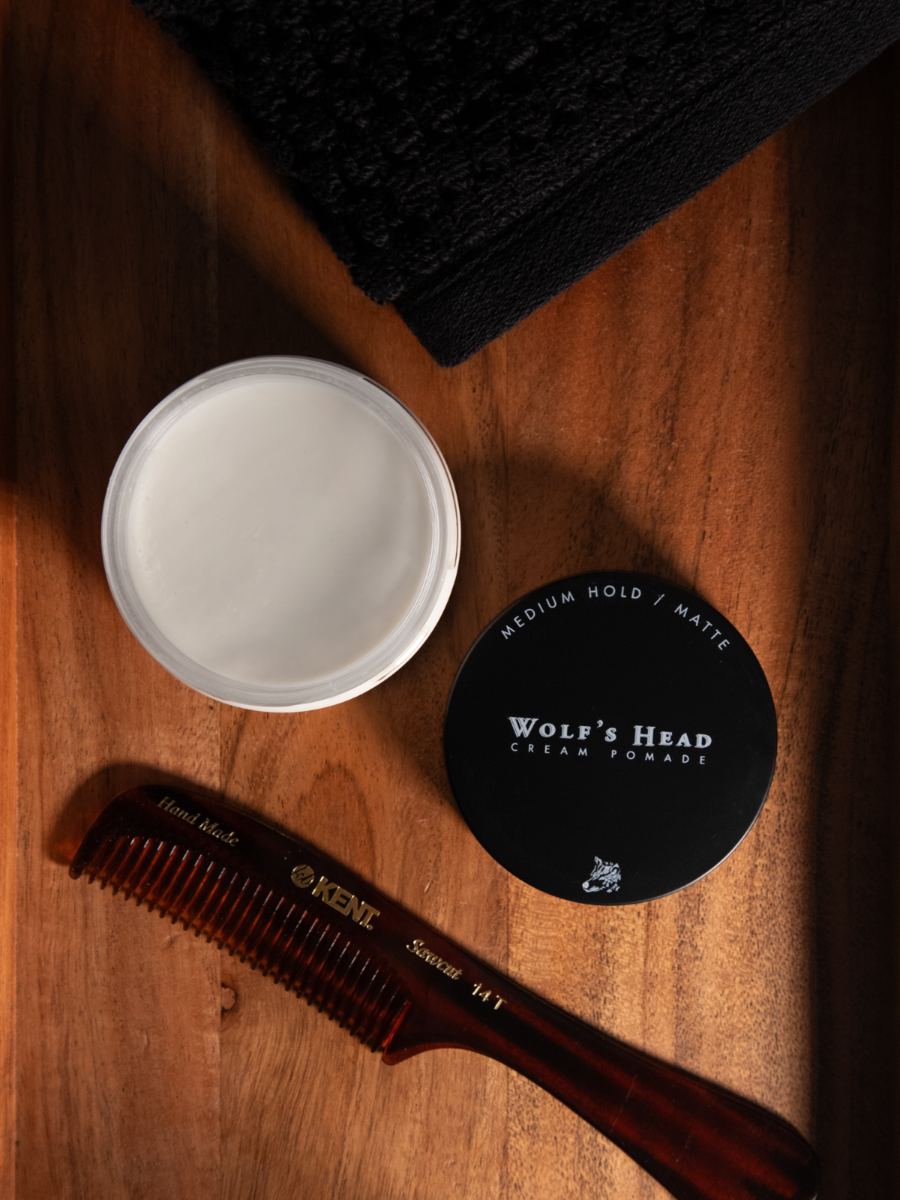 Open jar of Wolf’s Head Cream Pomade and a handled Kent Comb, medium hold, matte finish hair product for soft, natural texture. Ideal for casual, everyday grooming routines.