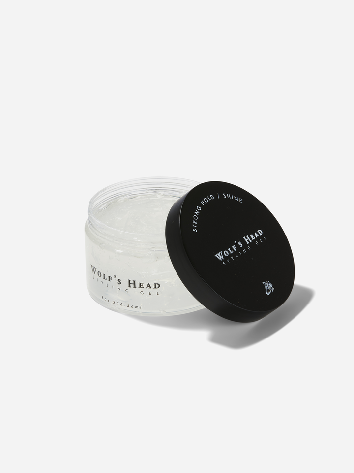 Open jar of Wolf’s Head Styling Gel Pomade with lid beside it, firm hold, high-shine styling gel designed for long-lasting control and a polished look.