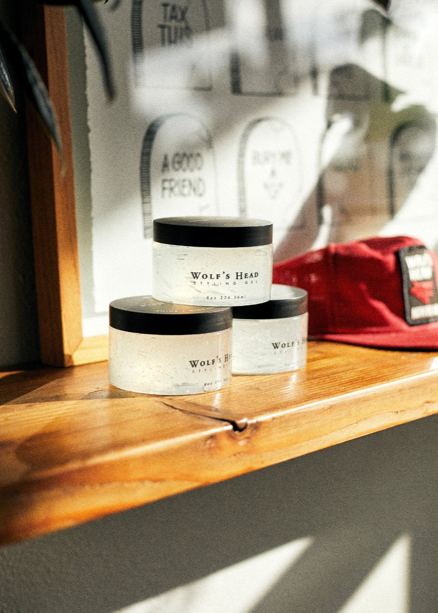 Wolf’s Head Styling Gel Pomades displayed on wooden shelf – strong hold high shine finish - professional-grade grooming product trusted - made in California