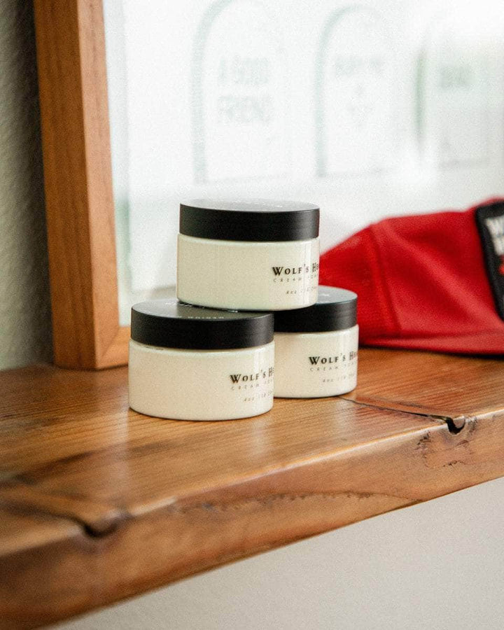 Wolf’s Head Cream Pomades displayed on wooden shelf – medium hold matte finish - professional-grade grooming product trusted by California barbers