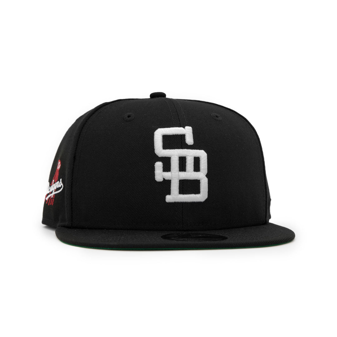 Santa Barbara Dodgers x New Era Black 9FIFTY Snapback Hat – Quality Headwear & Classic Streetwear Baseball Cap. Available at Wolf's Head. Front Right