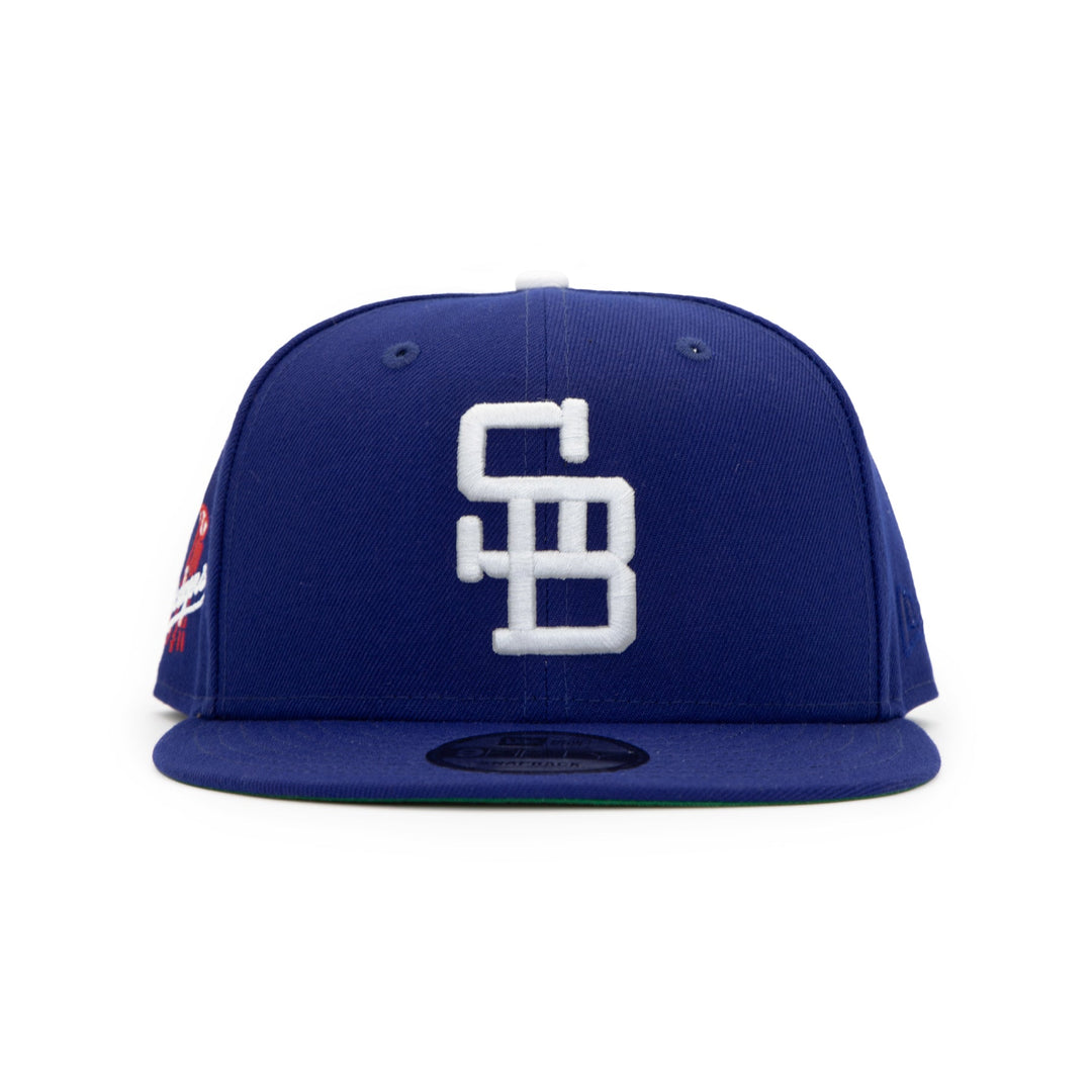 Santa Barbara Dodgers x New Era Dodger Blue 9FIFTY Snapback Hat – Quality Headwear & Classic Streetwear Baseball Cap. Available at Wolf's Head.