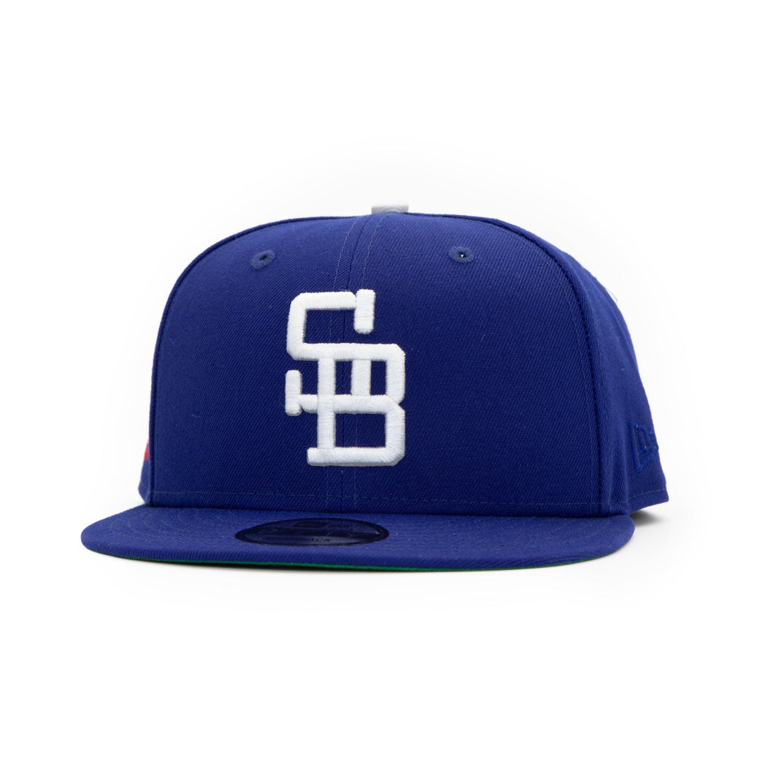 Santa Barbara Dodgers x New Era Dodger Blue 9FIFTY Snapback Hat – Quality Headwear & Classic Streetwear Baseball Cap. Available at Wolf's Head. Front Left