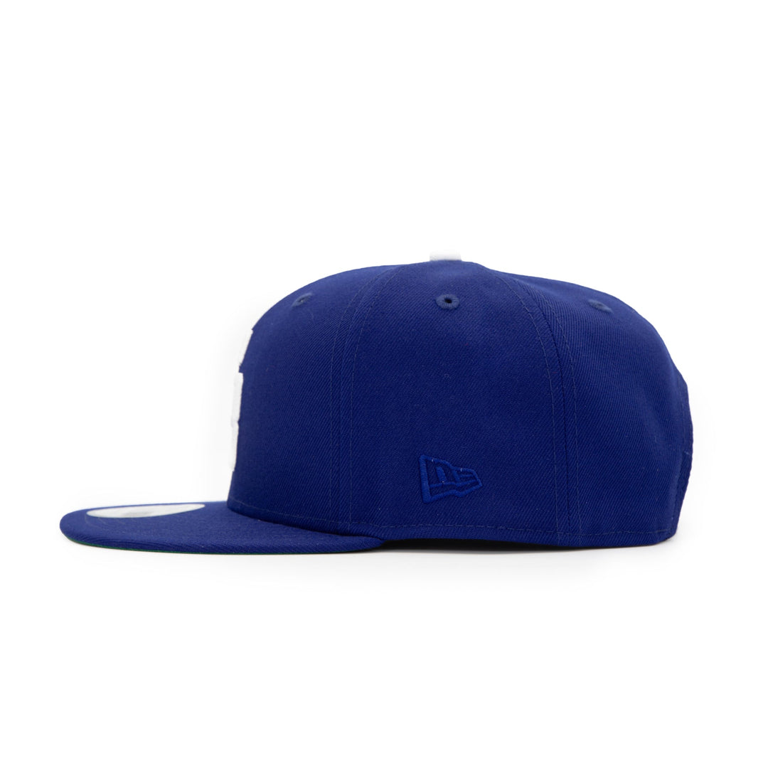 Santa Barbara Dodgers x New Era Dodger Blue 9FIFTY Snapback Hat – Quality Headwear & Classic Streetwear Baseball Cap. Available at Wolf's Head. Left