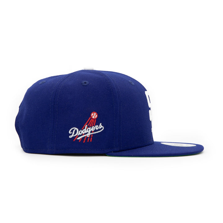 Santa Barbara Dodgers x New Era Dodger Blue 9FIFTY Snapback Hat – Quality Headwear & Classic Streetwear Baseball Cap. Available at Wolf's Head. Right