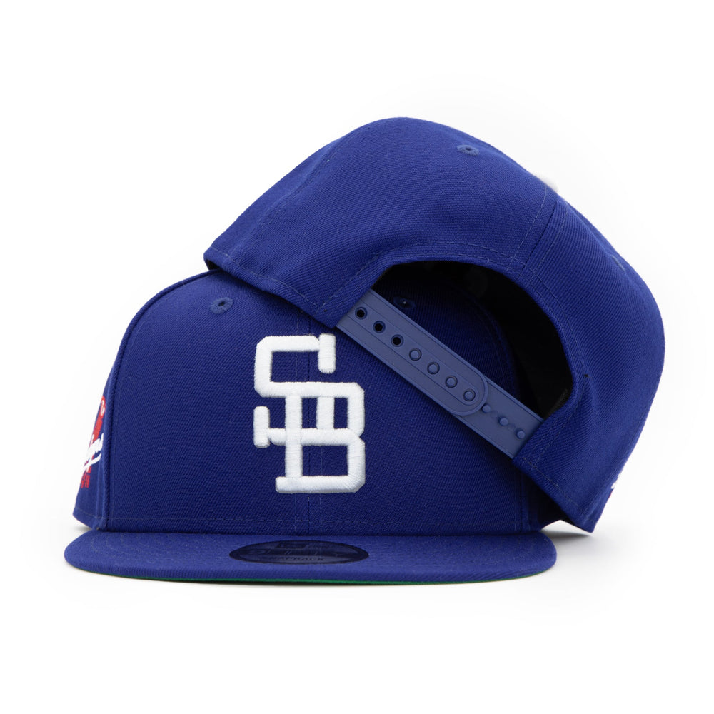 Santa Barbara Dodgers x New Era Dodger Blue 9FIFTY Snapback Hat – Quality Headwear & Classic Streetwear Baseball Cap. Available at Wolf's Head. Stacked