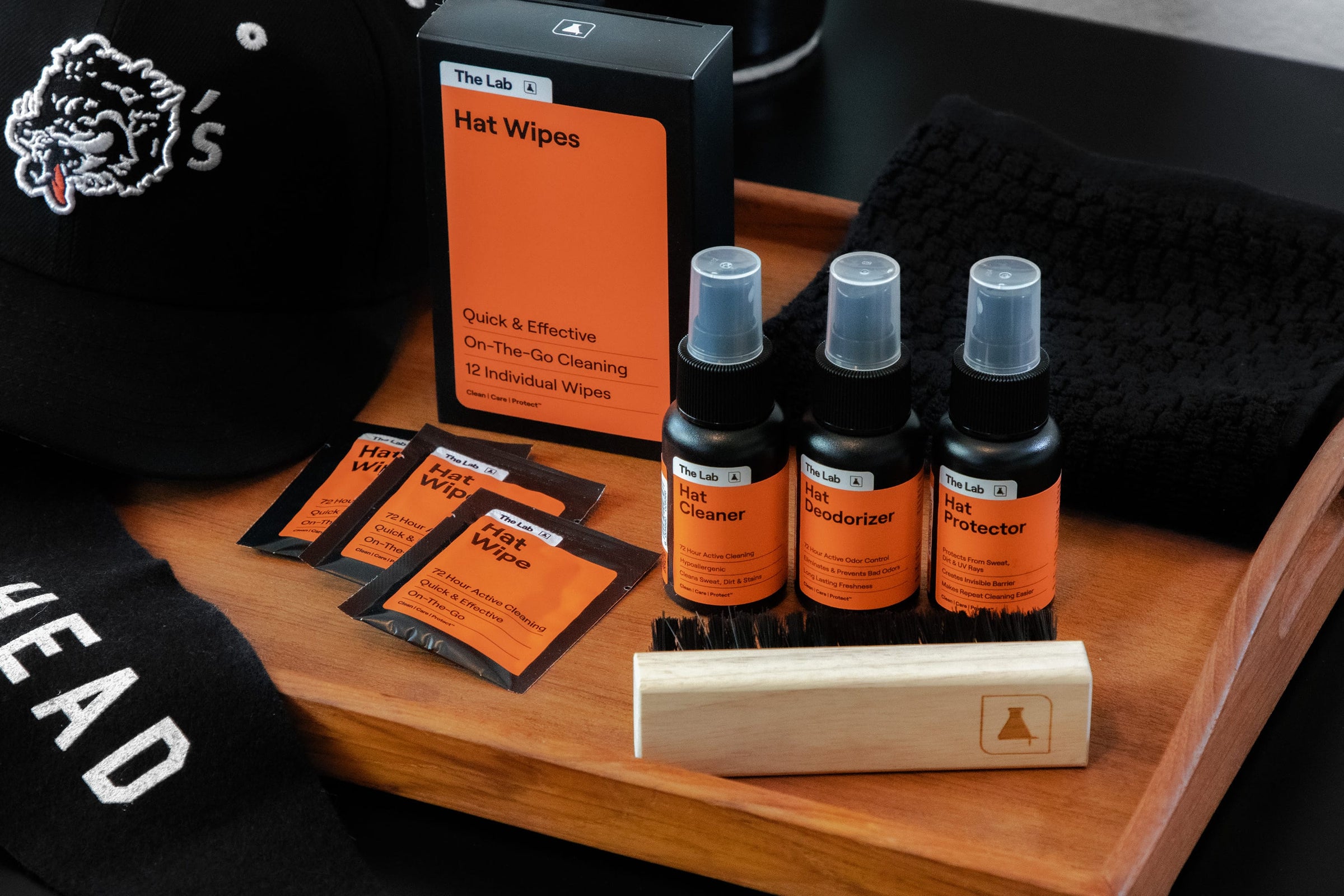 The Lab Hat Care Kit and Hat Care Wipes 12 pack laid out. Probiotic Hat Cleaner, Deodorizer, Protector, Premium Brush and on the go Wipes. Complete hat care solution available at Wolf's Head.