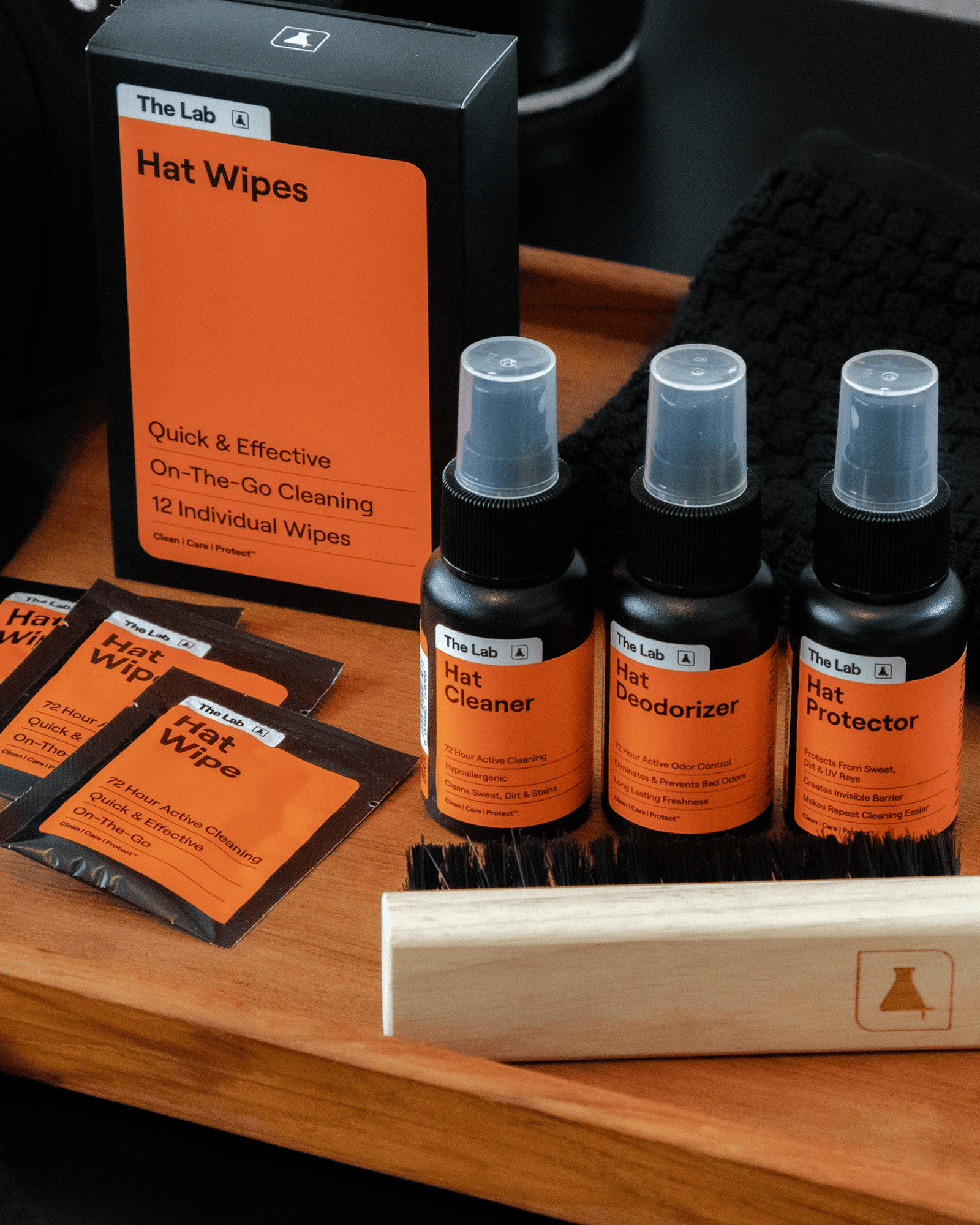 The Lab Hat Care Kit and Hat Care Wipes 12 pack laid out. Probiotic Hat Cleaner, Deodorizer, Protector, Premium Brush and on the go Wipes. Complete hat care solution available at Wolf's Head.