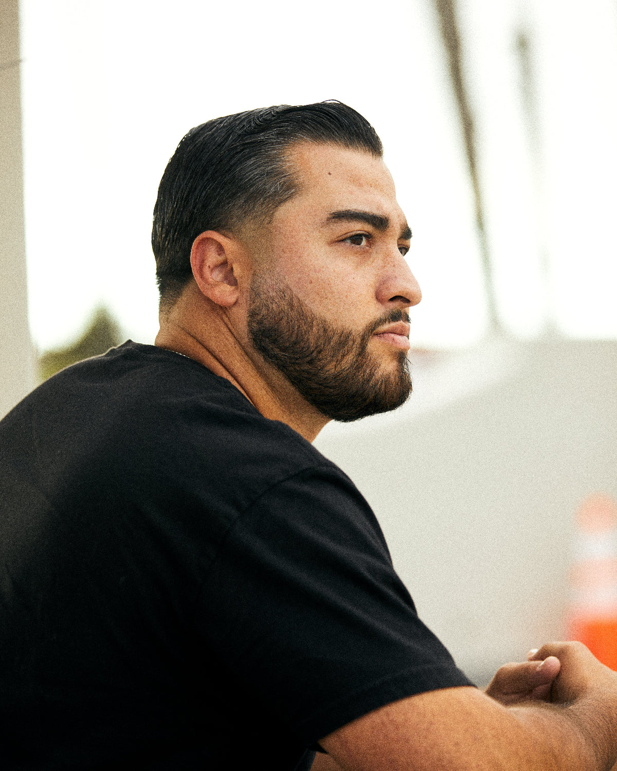 Wolf’s Head Styling Gel Pomade used to create a classic controlled hairstyle on a man wearing a black shirt—strong hold, high shine, premium water-based grooming product for a clean, polished look.
